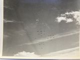 a lot of airplanes flying in the sky in this picture