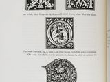 an open book with a drawing of a letter m and a picture of a man