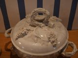 a white bowl with a monkey on it on a wooden table