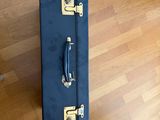 a blue suitcase sitting on a hard wood floor