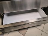 a stainless steel drawer with a white paper in it