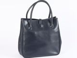 a black leather handbag on a white background