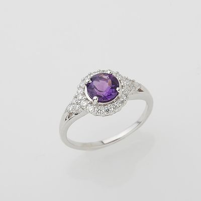 an oval amethorate and diamond ring on a white background
