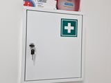 a white box with a green cross on top of it