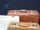 three suitcases sitting next to each other on a table