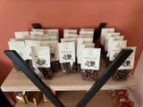 many chocolate candies on a wooden shelf in a room