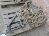 a pile of rope sitting on a pallet next to a brick wall