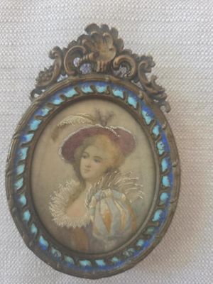 an old picture of a woman wearing a hat and a blue and white dress