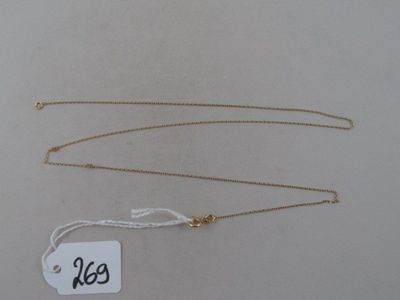 two gold necklaces with a price tag on a white background