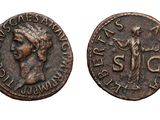 an old coin with the image of a woman holding a sword
