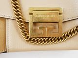 beige leather clutch bag with golden chain strap and metal clasp