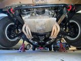 a close up view of a car ' s engine and exhaust pipe