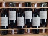 many bottles of wine sitting in a wooden case