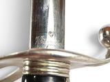 a close up of a silver sword with a black handle