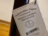 a person holding a bottle of wine with a label on it