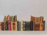many books stacked on top of each other on a table