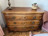 a dresser in a room with a lamp on top of it