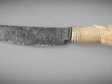 a knife with a wooden handle on a table