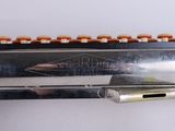 a knife that is laying on top of a piece of metal