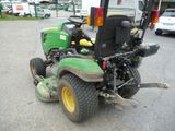 a picture of a lawn mower parked in a parking lot