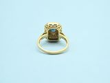 an image of a gold ring with a blue stone in the center