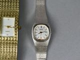 two watches sitting next to each other on a table