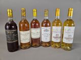 several bottles of wine are lined up on a table