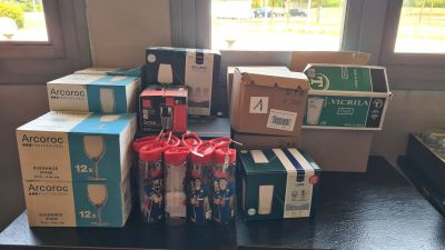 many boxes of sodas sitting on a table in front of a window