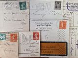 many old postcards and envelopes on the table