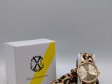 an image of a watch with a leopard print strap next to a box