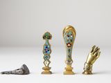 three pieces of art that are sitting on a table
