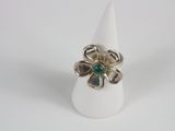 a close up of a ring with a flower on top of it