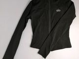 a black jacket with the word alo on it sitting on a white surface