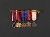 a close up of a row of medals on a black surface