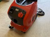 an image of a red vacuum cleaner sitting on top of a hard wood floor