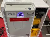 a small refrigerator that has a purple light on top of it