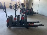 many different types of hand trucks parked in a garage