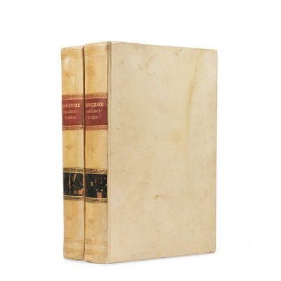 two books sitting on top of each other on a white surface