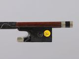 a violin bow that is attached to a piece of wood