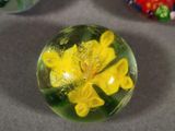 three glass marbles sitting on top of a table next to each other