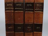 three old books sitting on top of each other on a white surface