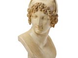 a white marble bust of a woman with curly hair