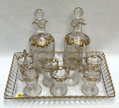 bottles and glasses on a tray with a bird on the top