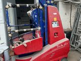 a red and blue scissor sitting in a garage