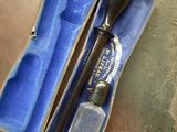 a blue case with a black handle and a black pen in it