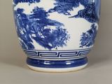 a large blue and white vase with trees on it