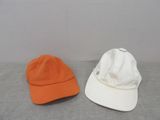 two hats that are sitting next to each other on a table