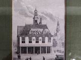 an old picture of a building with a clock tower on top of it