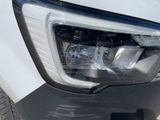 a close up of a car ' s headlight on the side of the road