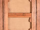 an old picture frame with a piece of paper hanging from it